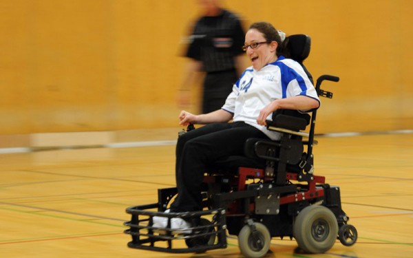 Talia speeds down the court during a power soccer game