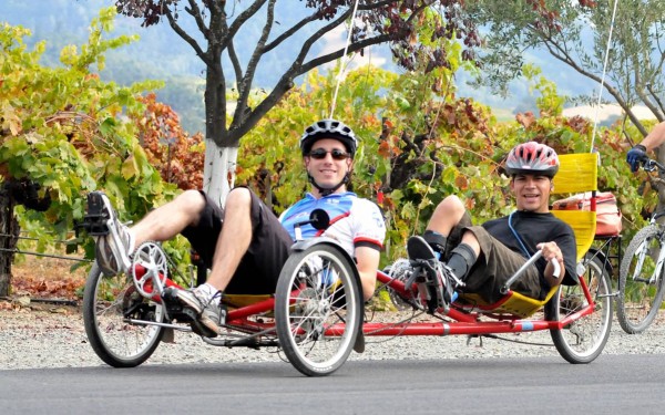 Dan & Danny ride a recumbent tandem cycle at the Rev