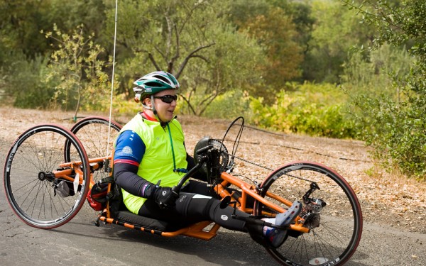 A handcyclist cruises past gorgeous scenery in Sonoma