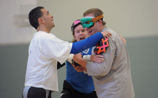 Three members of a goalball team congratulate each other after a game