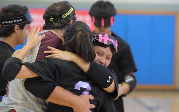 A goalball team celebrates together after a match