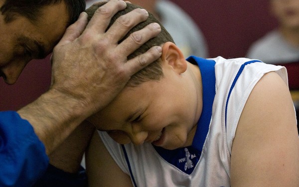 Coach Trooper Johnson shows one of his players some love