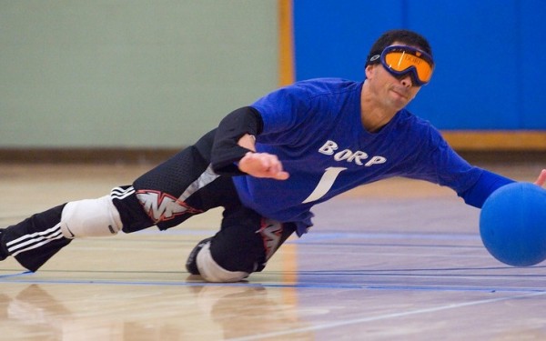 Roger Acuna dives to make a stop in a goalball game