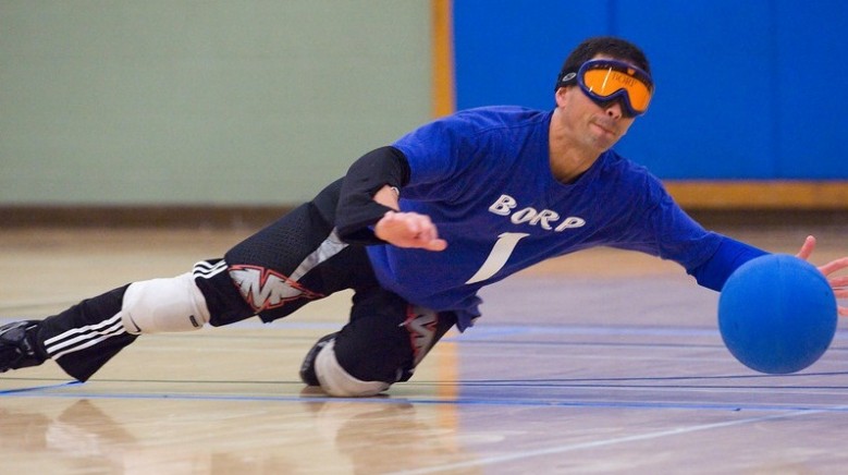 Roger Acuna dives to make a stop in a goalball game