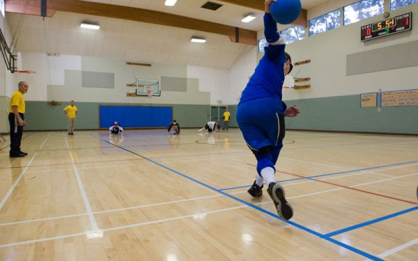 A view of a goalball player about to roll a shot down the length of the court