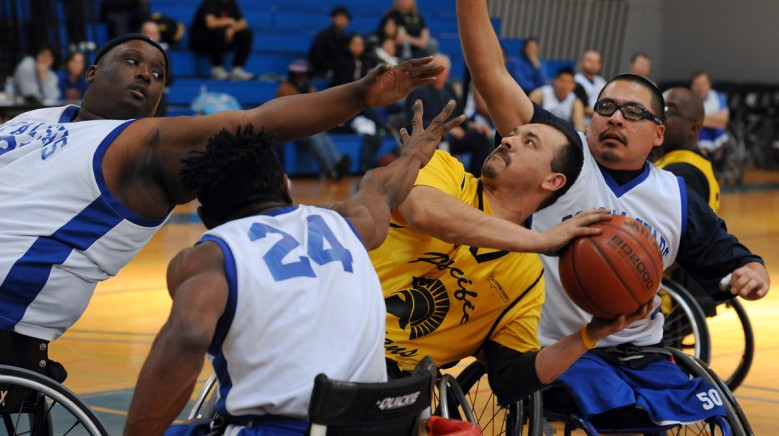 BORP defenders triple team an oppenent during a wheelchair basketball game