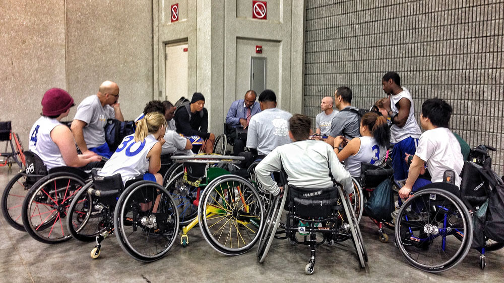Members of the 2014 Golden State Road Warriros and BORP Jr. Road Warriors huddle together
