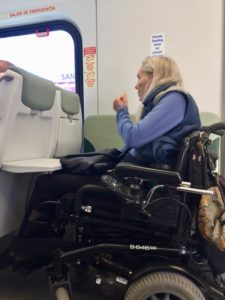 A womn in a power chair riding the SMART train