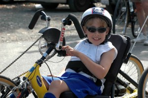 Ernesto poses for a photo on a yellow handcycle