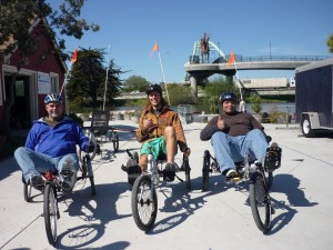 Three Vets on recumbent bikes give the thumbs up at BORP Cycling Center