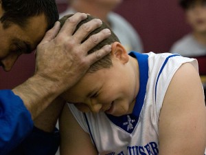 Coach Trooper Johnson shows one of his players some love