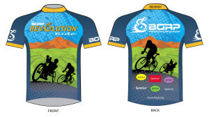 The 2014 Rev jersey features silouettes of a handcyclist and a two-wheeled cyclist with a green valley and a mountain range in the background