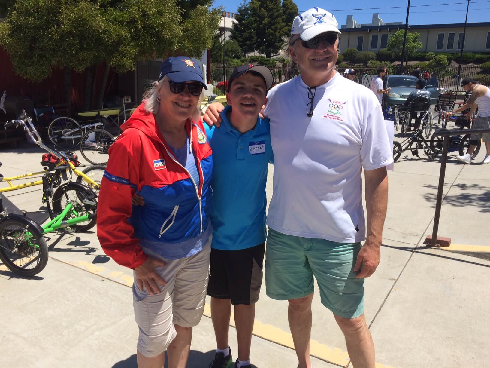 All smiles after learning to row, a young BORP participant poses with two former Olympic rowers, Charles Alterkruse (1980 & 1988 Olympics) and Liz Miles (1984 Olympics).