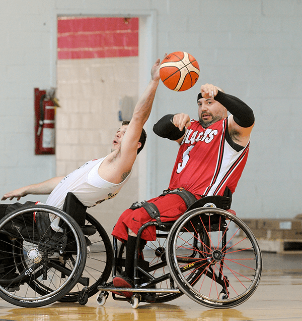 Player attempts to block a pass, wheelchair basketball