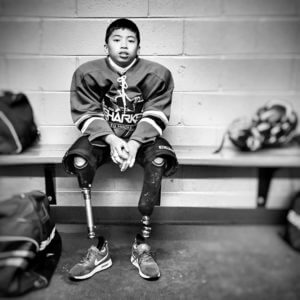 Shark Sled Hockey player in the locker room 