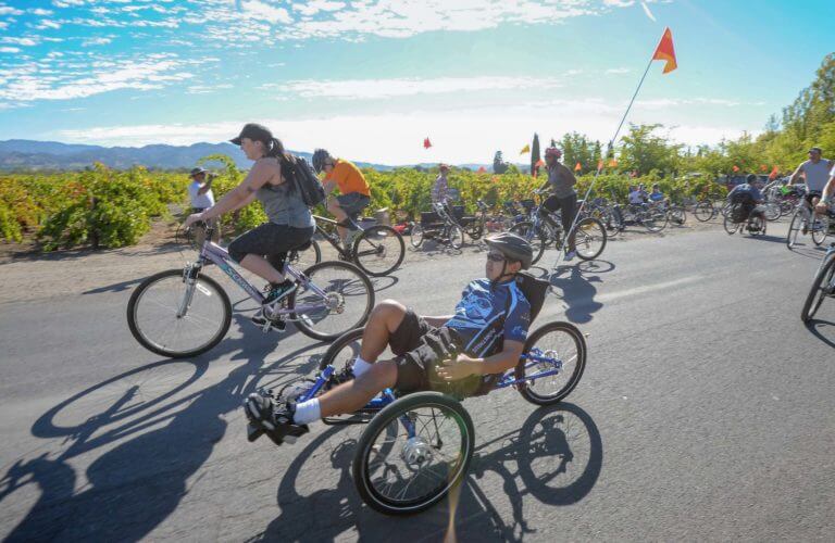 Large group of riders on adaptive and upright bikes
