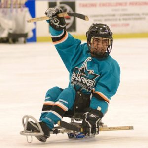 sled hockey player smiling on ice