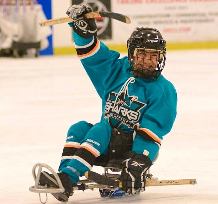 sled hockey player smiling on ice