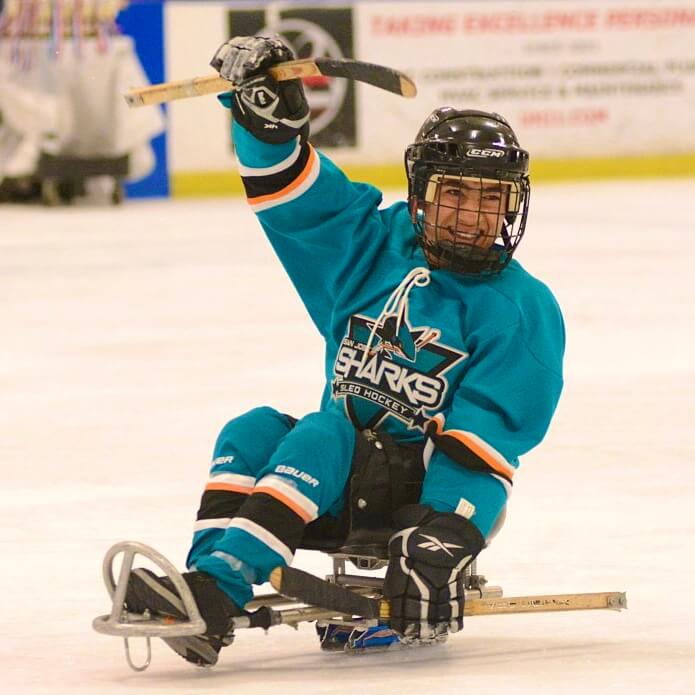 sled hockey player smiling on ice