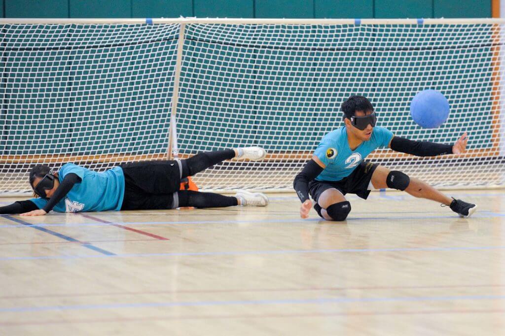 Goalball players dive for ball