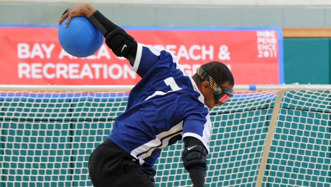 Goalball athlete throwing the ball