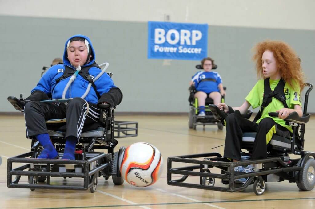 youth power soccer players vie for the ball on BORP court