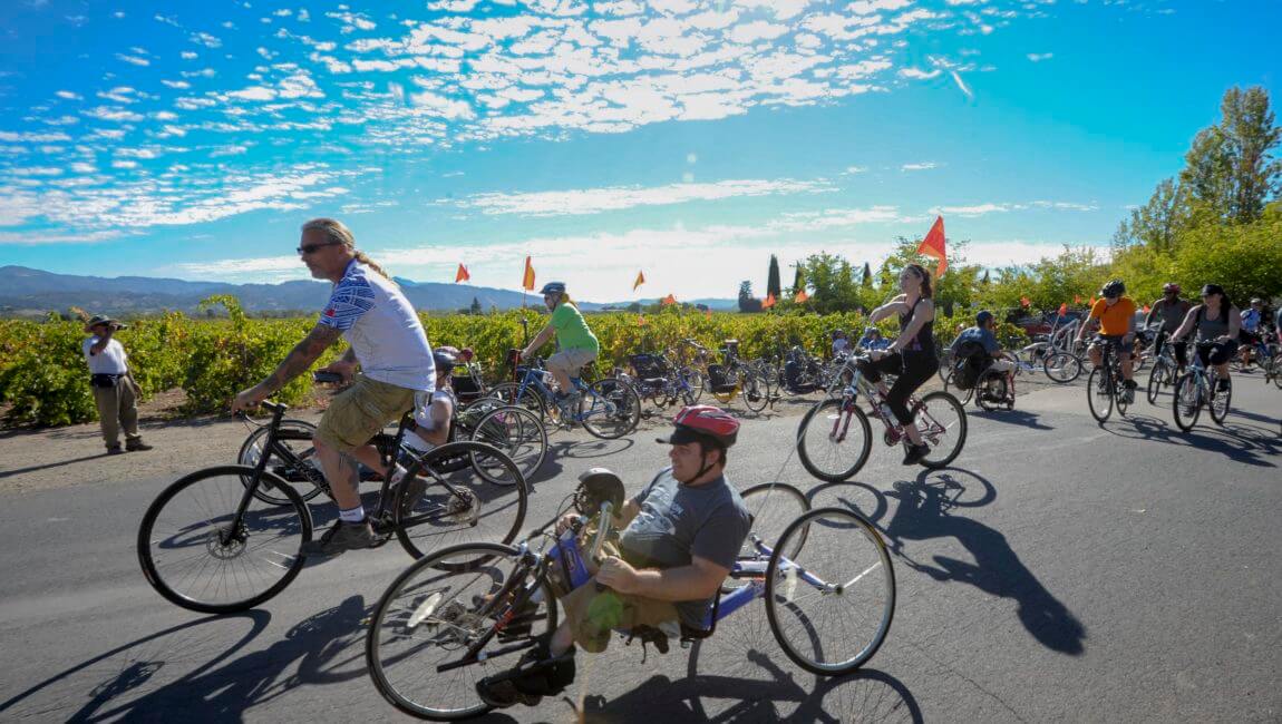 Cyclists on upright and hand cycles riding together