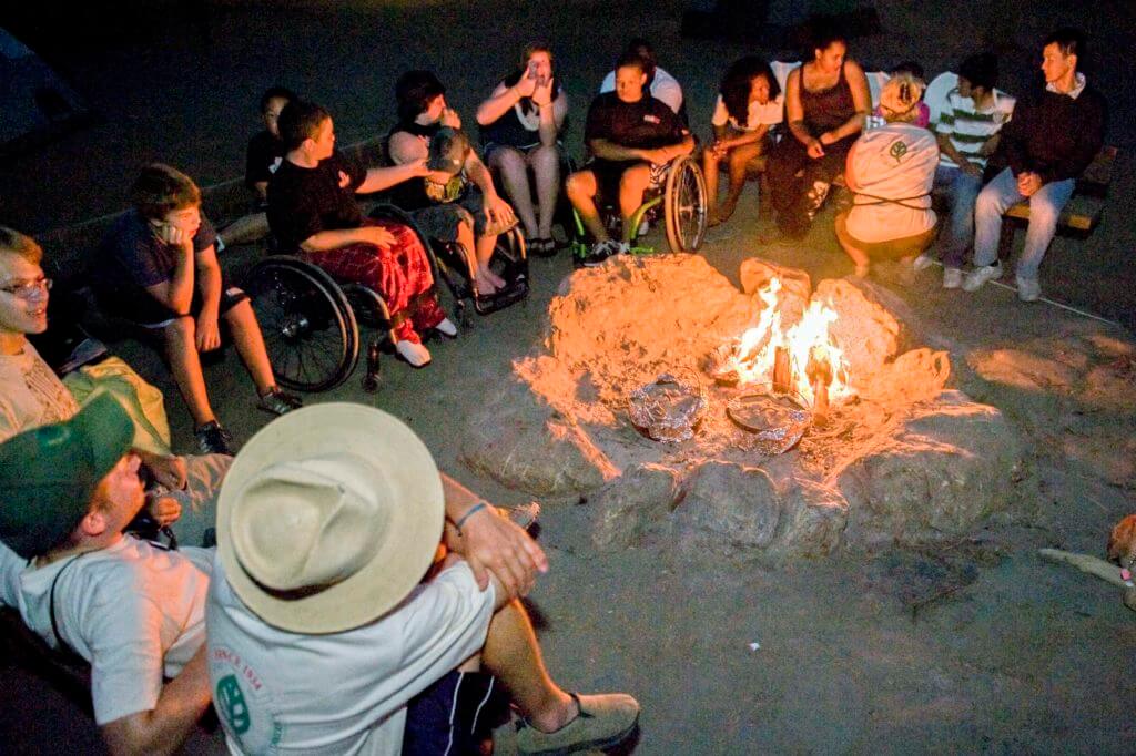 Adventures and Outings Youth around a fire pit