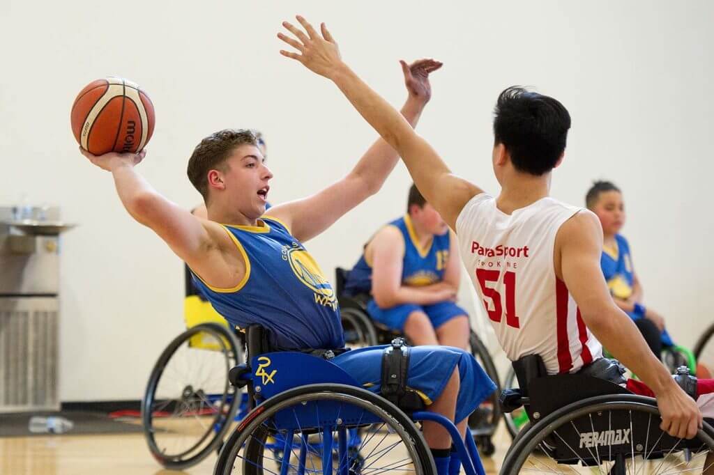 male youth basketball player passing ball