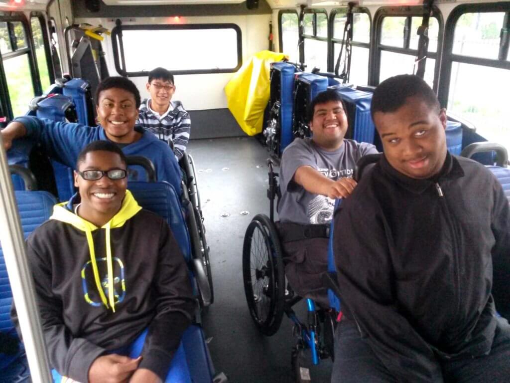 BORP participants on the bus smiling happily