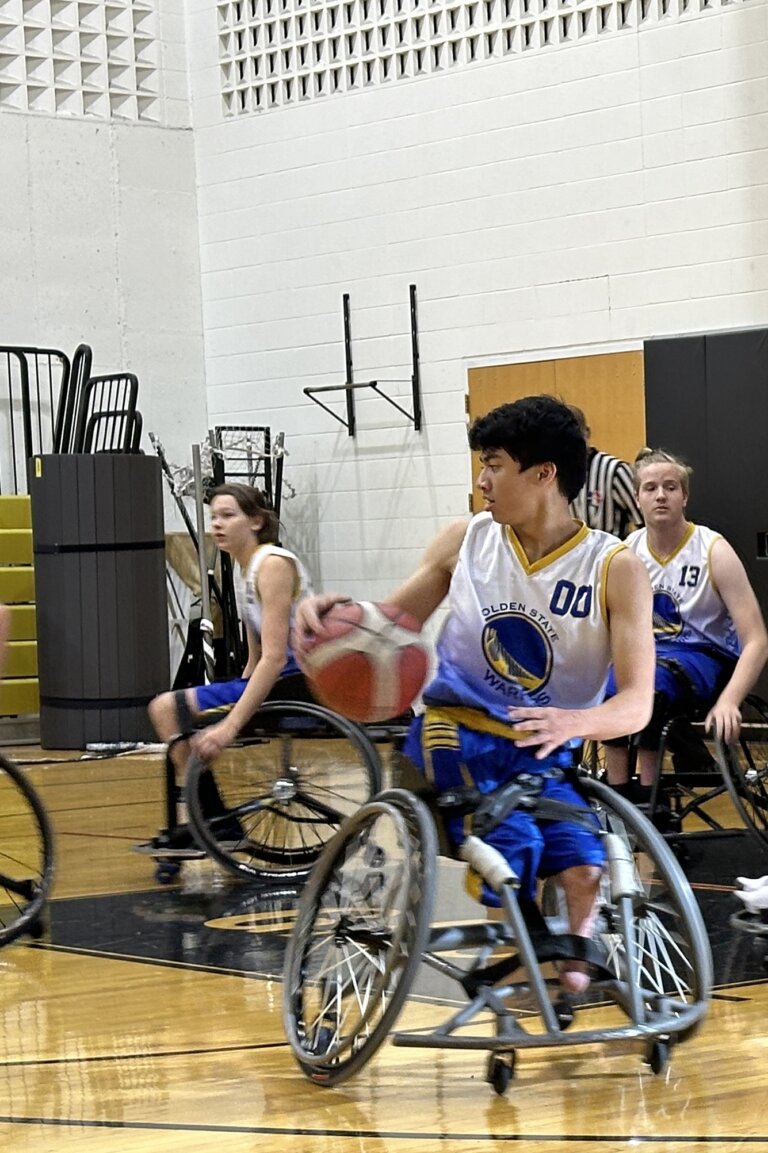 Action on the court, three warriors in mid-play