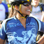 Rider with sun glasses wearing the 2013 Revolution Ride jersey with a big smile.