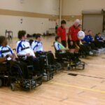 Power soccer athletes at refs