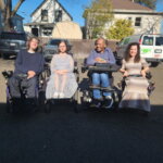John Madigan with three other power chair users