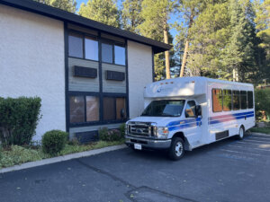 Wheelchair accessible van with BORP logo parked in front of building