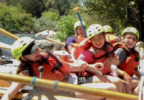 Young girls laughing together on raft